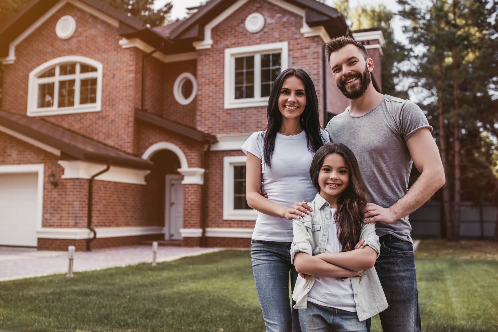 Happy family outside their new home